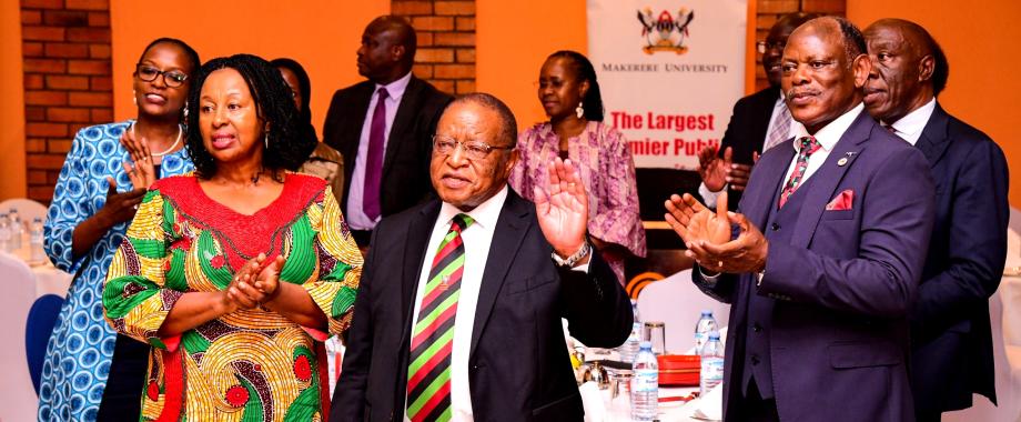 Left to Right: Chaiperson of Council-Mrs. Lorna Magara, Mrs. Specioza Suruma, Chancellor-Prof. Ezra Suruma, Vice Chancellor-Prof. Barnabas Nawangwe, DVCFA-Prof. Henry Alinaitwe and other guests join in singing Amazing Grace during the dinner on 20th December 2024. 